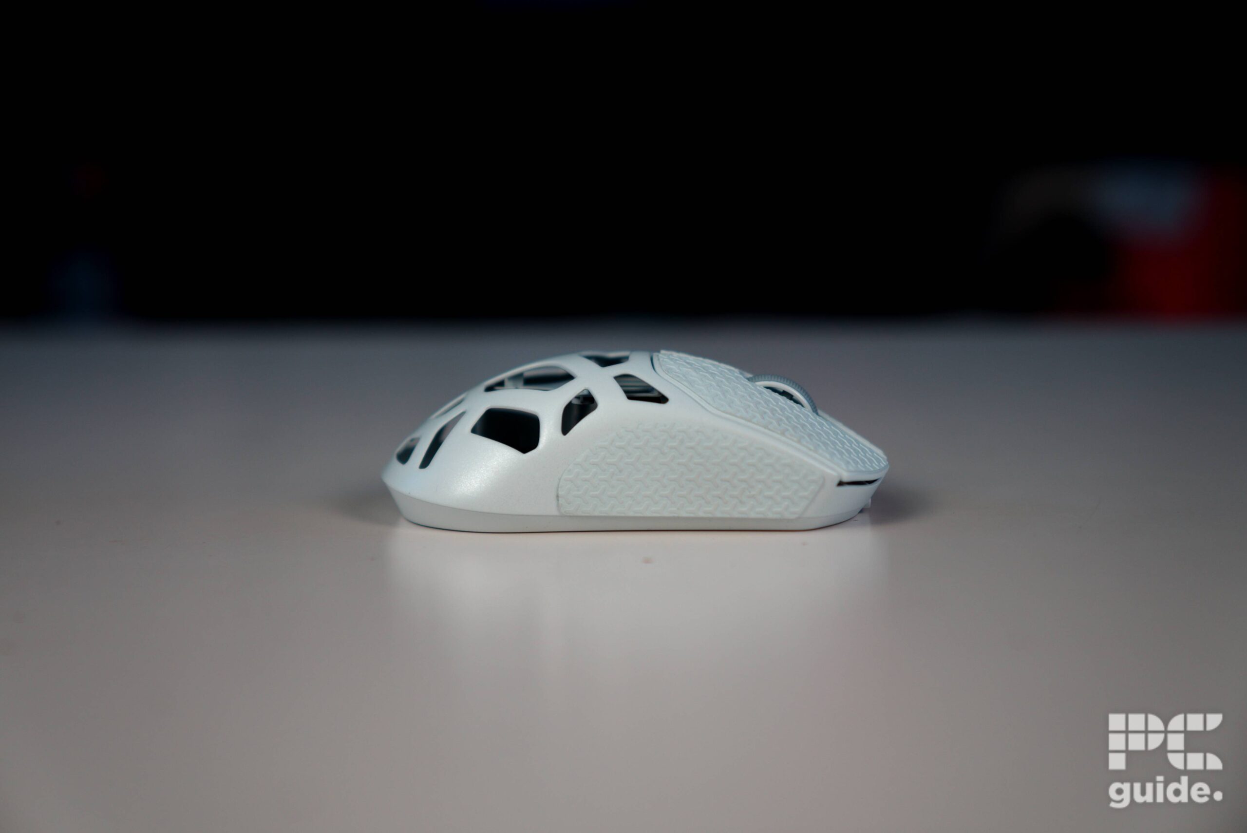 The right side of the white Corsair Sabre v2 PRO Wireless MG sitting on the table.